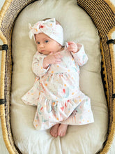 Baby girl wearing pink Princess organic cotton dress in basket brand Duper DuDu design by a NICU nurse