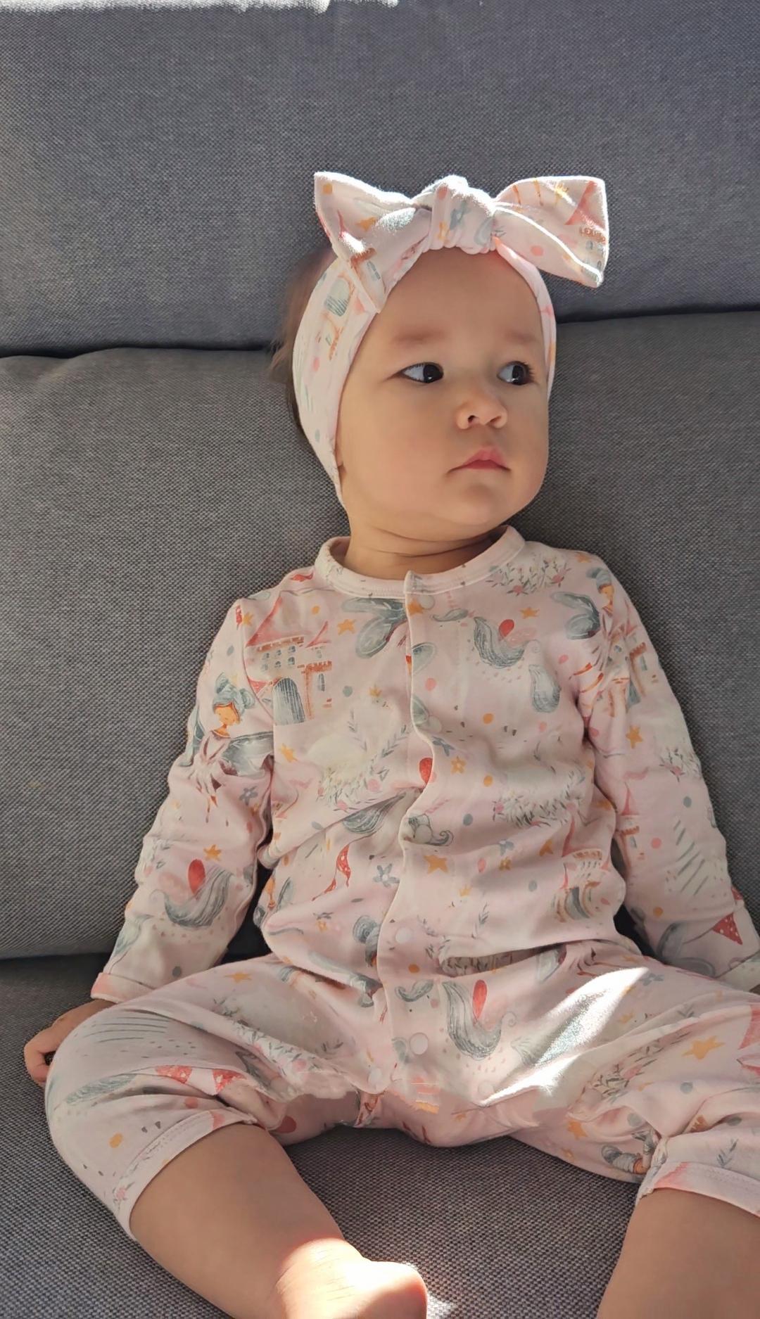 Baby girl wearing pink fairy print organic cotton sleepsuit with snaps brand Duper DuDu design by a NICU nurse