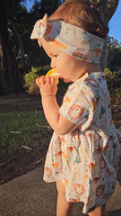 Baby girl wearing Wild Team organic cotton bow accessory brand Duper DuDu, design by a NICU nurse
