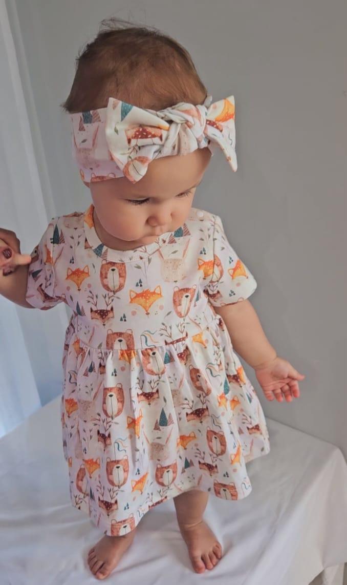 Baby girl wearing Wild Team organic cotton bow accessory with set