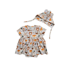 Baby wearing cute organic cotton hat with animal ears and ties