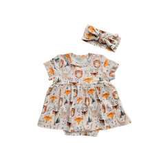 Flat lay of Wild Team organic cotton baby dress onesie with bow brand Duper DuDu design by a NICU nurse