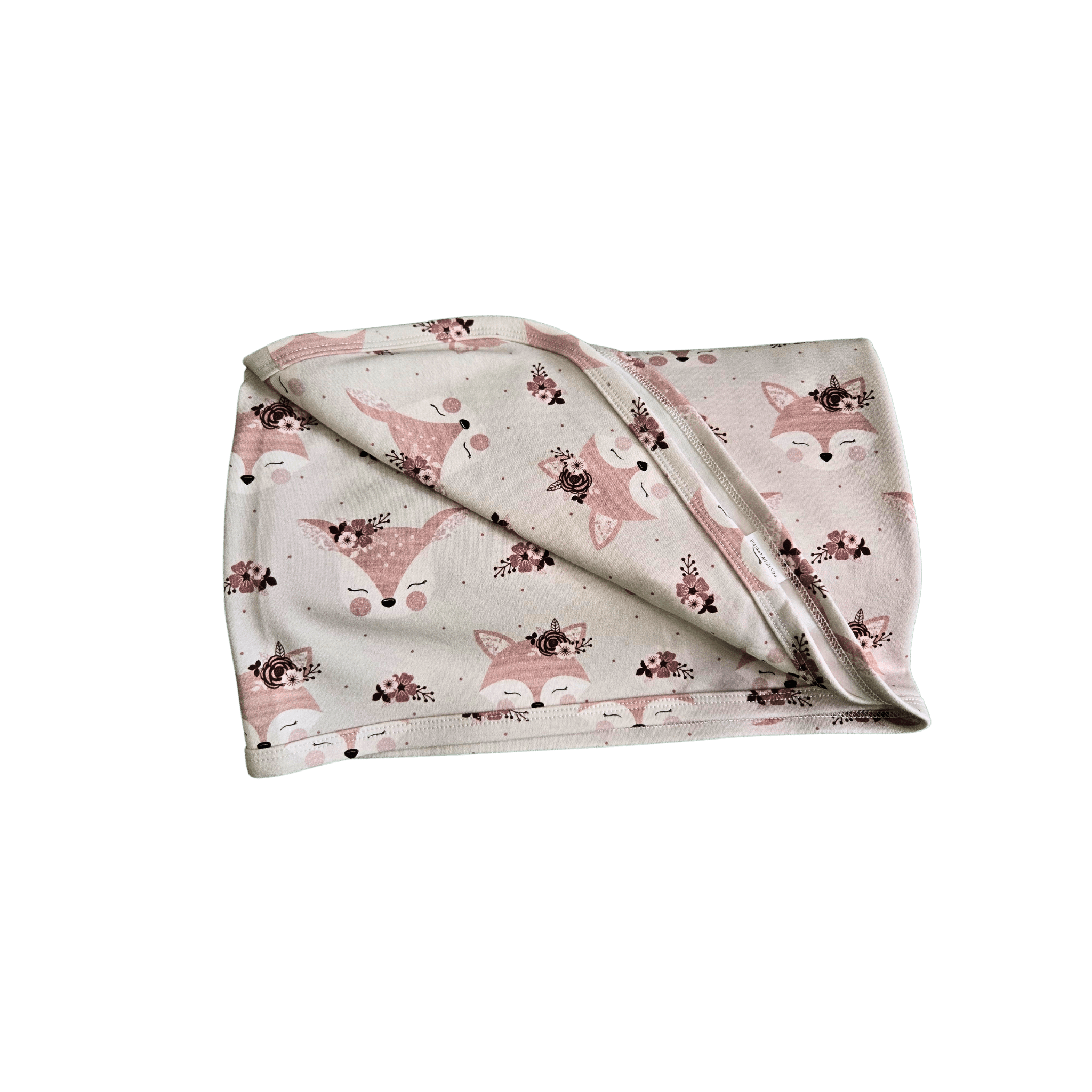 Soft organic cotton swaddle draped over nursery chair showing fox texture